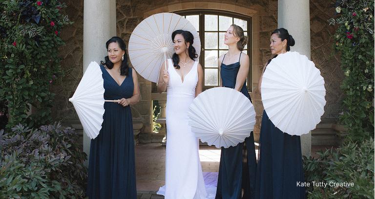 Bride and her bridesmaid standing infront of the garden