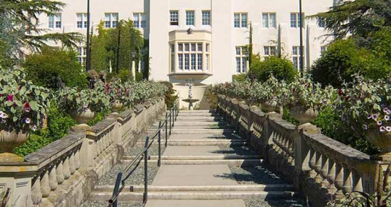 Concrete staircase leading up to a tall white building at Royal Roads